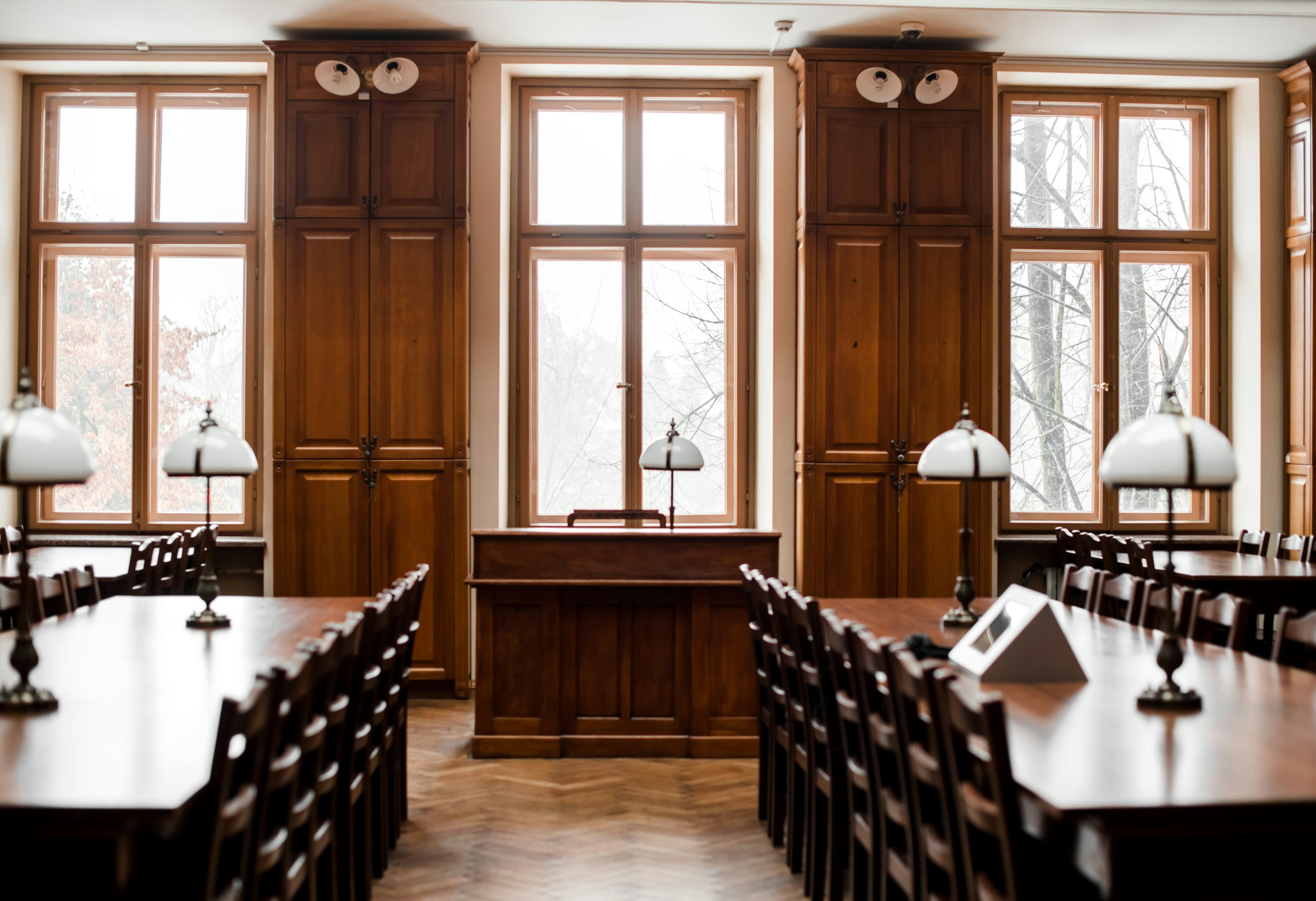 Photo of a study hall with wooden tables and chairs.